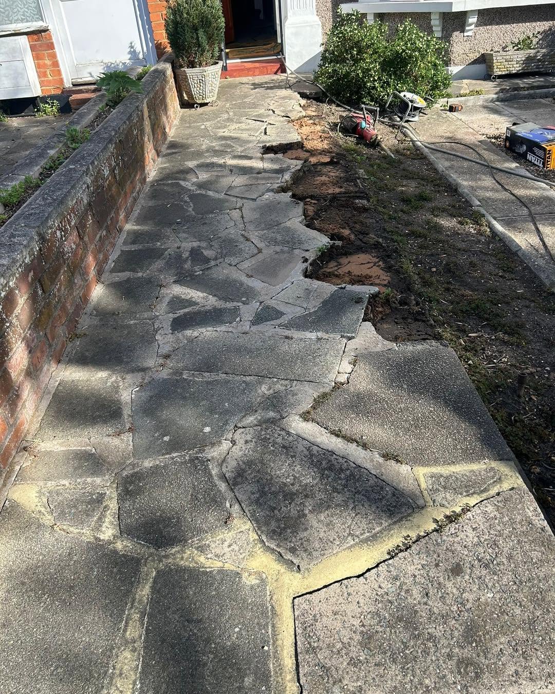 Cracked driveway surface before replacement