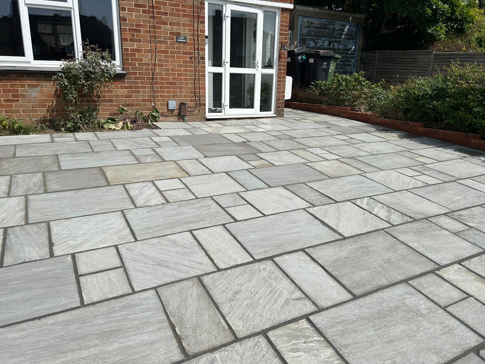 Wide grey sandstone patio and garden path